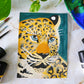 amur leopard gouache painting flat lay with paints and paintbrushes to show size